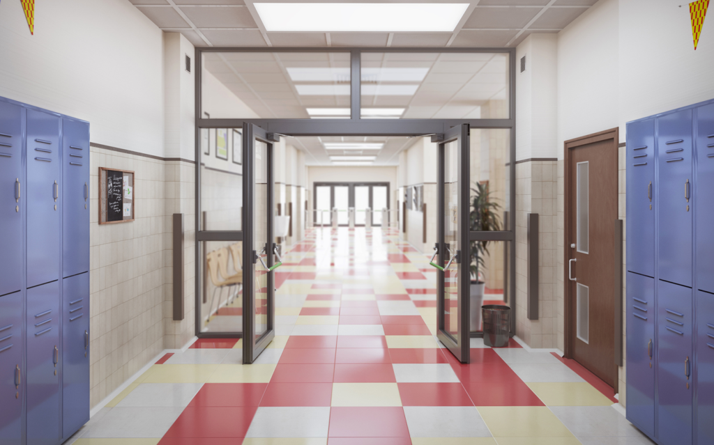 Image of a school hallways with red and white checkered floors, white walls, blue lockers and glass doors with black trim.