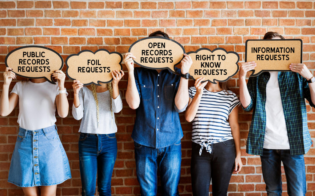 people holding signs with FOIA related phrases on thought bubbles