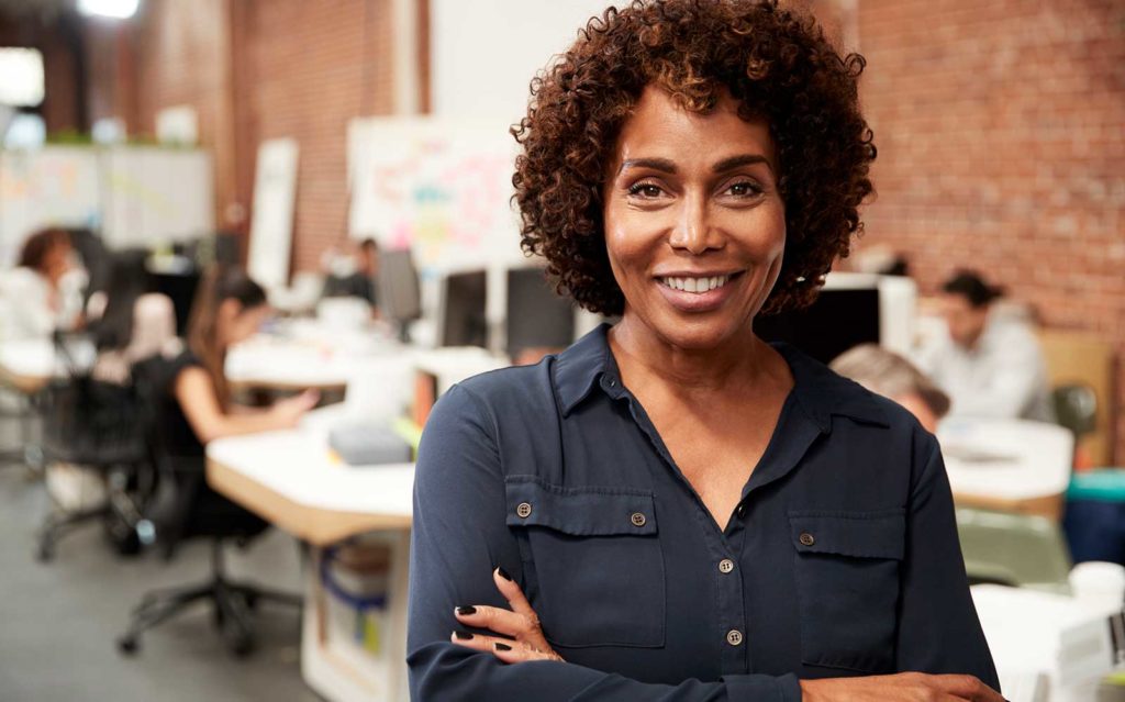 woman smiling with arms crossed