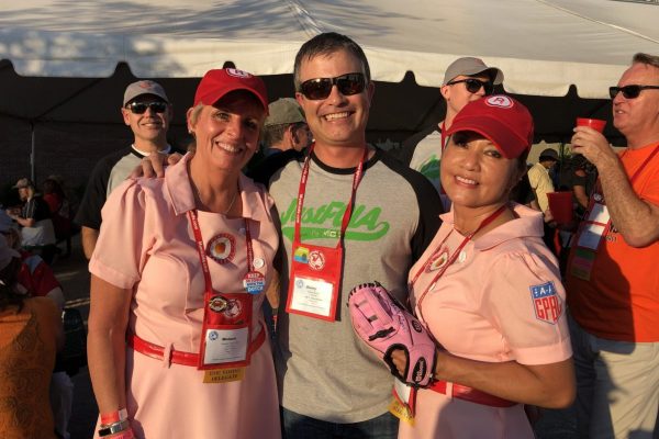 Donny Barstow with municipal clerks dressed in "Peaches" outfits for a baseball themed event