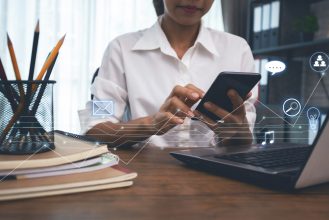 business woman working from home using smartphone and computer